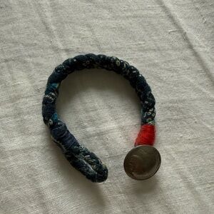 Indigo-dyed antique fabric bracelet with Indian head cent coin